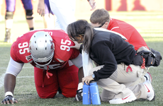 Sophomore defensive lineman Edet Udoh receives attention from athletic trainers Courtney Dossett and Shaun Duhe after an injury during Saturdays game against Stephen F. Austin.