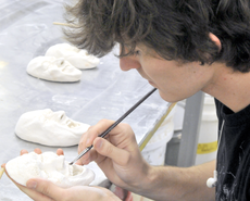 Cory Blanchard, art senior from Houma, works on pieces for his senior project, Face the Silence, Monday in Talbot Hall.