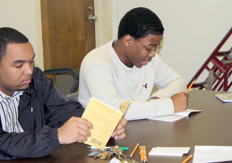 Melvin Harrison (left), assistant director for the Student Union, listens as Warren Snowden, freshman from Harvey, reads his part during Mondays rehearsal for the upcoming Nicholls Players production A Lesson Before Dying.