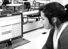 Hannah Songe, freshman from Houma, checks Blackboard on Nov. 15 in the student union. 