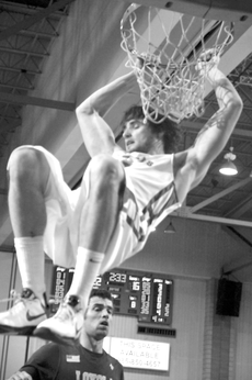 Senior guard/forward Anatoly Bose makes a slam dunk during the Dec. 8 game against Loyola.