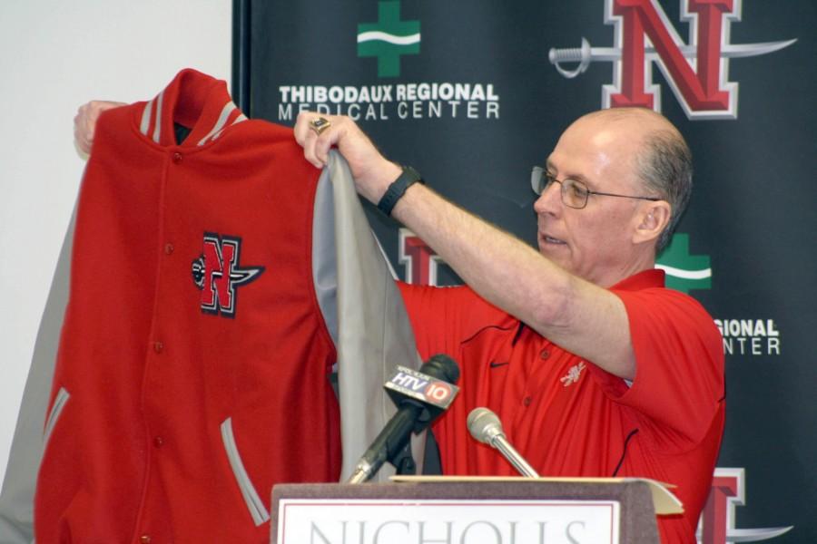 Head football coach Charlie Stubbs holds a letterman jacket during the National Signing Day press conference last week in the Century Room.