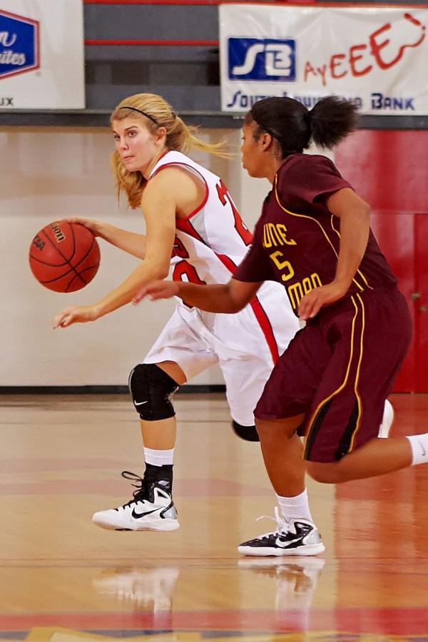 Freshman guard Ashley Adams dribbles past a Bethune-Cookman College player during the Dec. 15 game.