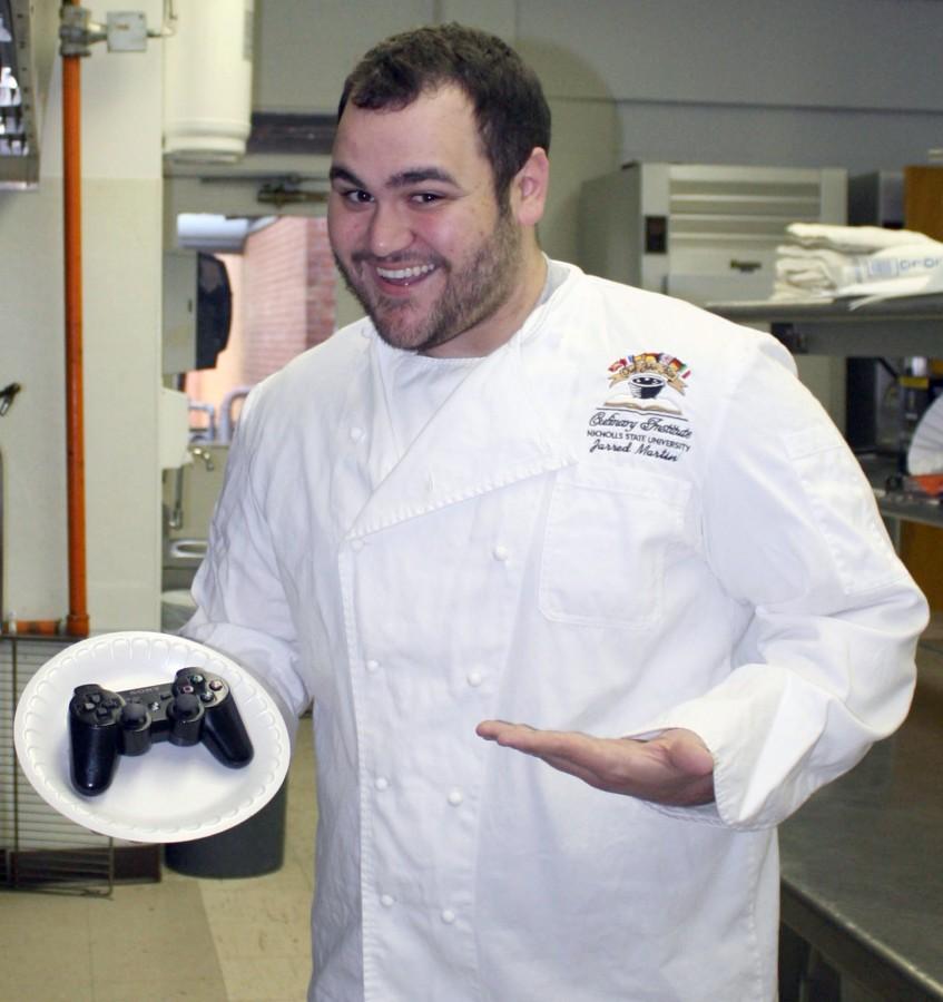 Jarred Martin, culinary arts junior from Vidalia, poses with a playstation controller on a plate because he enjoys playing Call of Duty