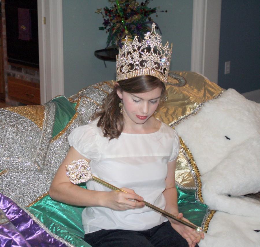 Caitlin Cowen, mass communication and graphic design junior from Thibodaux, looks at the scepter she received for being selected queen for the Krewe of Christopher on Monday at her home.