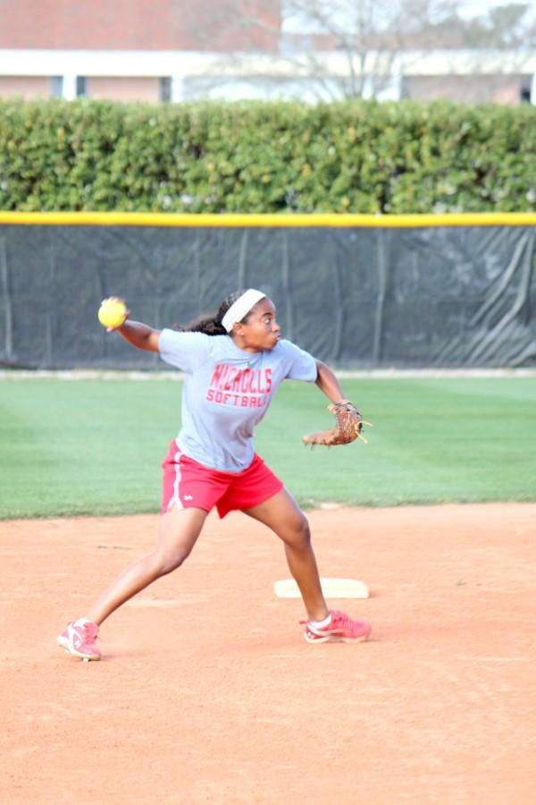 Junior shortstop Tsade Joubert throws the ball back into play during practice last week at the softball fiield.