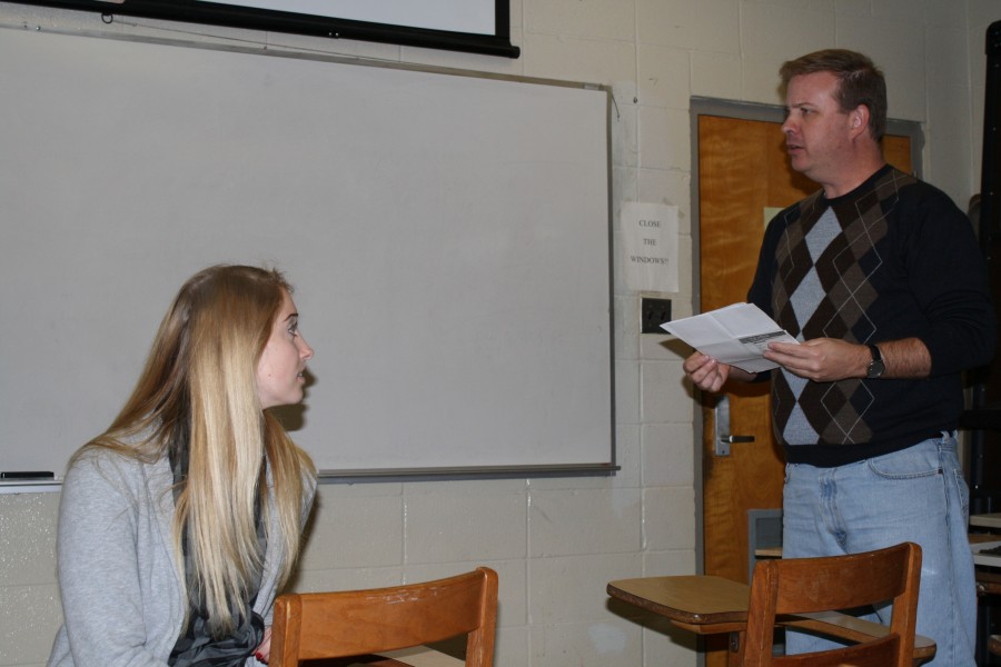 Dr. Brain Heck, advisor of math club and professor, reads the constatution while Kristi Caluaruso,sociology junior from Baton Rouge, listens during the math club meeting.