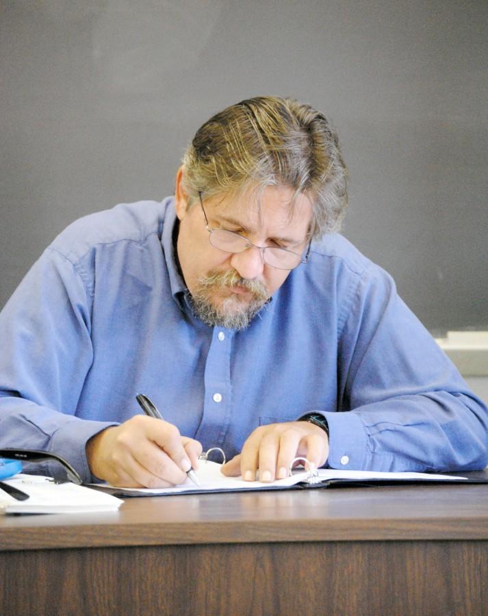 History instructor Scott Phipps takes roll in his history of western civilization class on Tuesday in Powell Hall.
