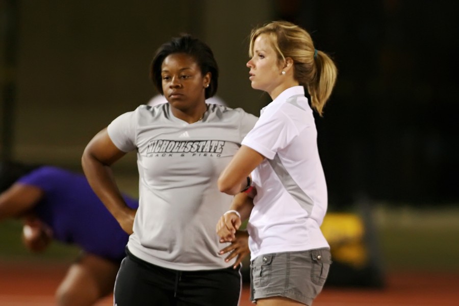 Cross country and track graduate assistant coach Leslie Bourgeois, right, shows support for junior Kerri Simmons during the shot put event at Friday’s LSU Relays.