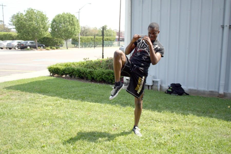 Mixed Martial Arts fighter Demetri McGee, freshman from Waggaman, practices his balance on Monday.