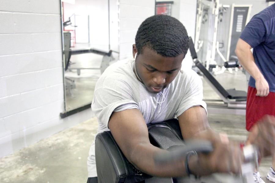 Ashton Gibson, freshman from Morgan City, lifts weights during his free time after class on April 4 in the weight lifting room.