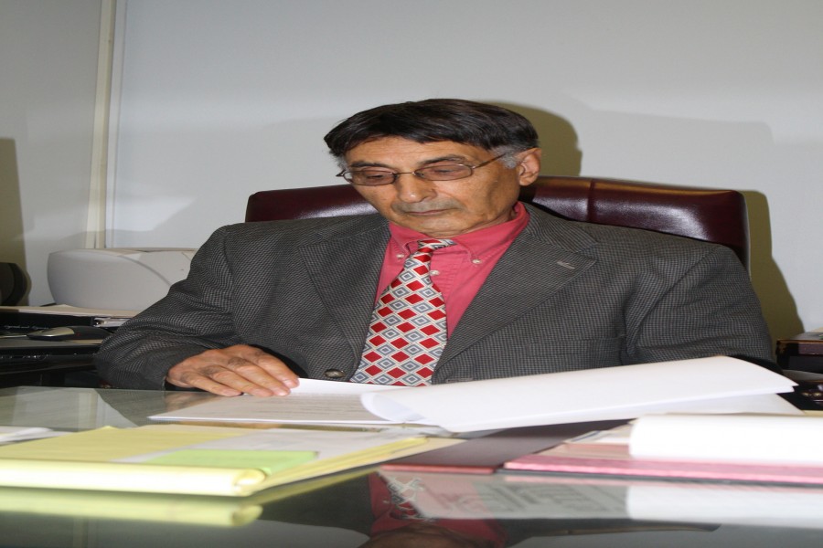 Dr. Badiollah Asrabadi looks over paperwork in his office on Thursday.