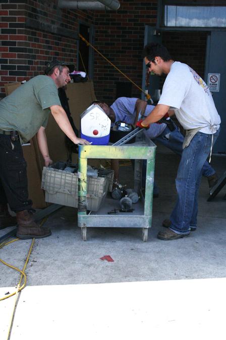 Workers unload parts and tools needed to install the new air conditioners in Ellender Hall.