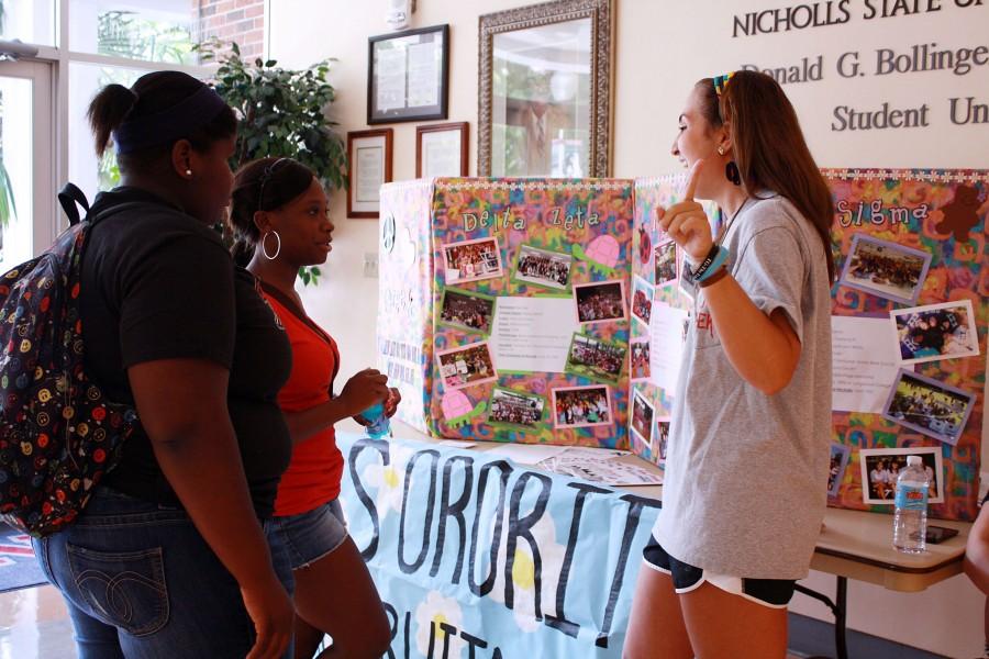 Lauren Pitre, Public Relations senior and recruitment counselor from Cut Off, shares a few facts with girls passing in the Student Union about soroity life on Aug. 22. 