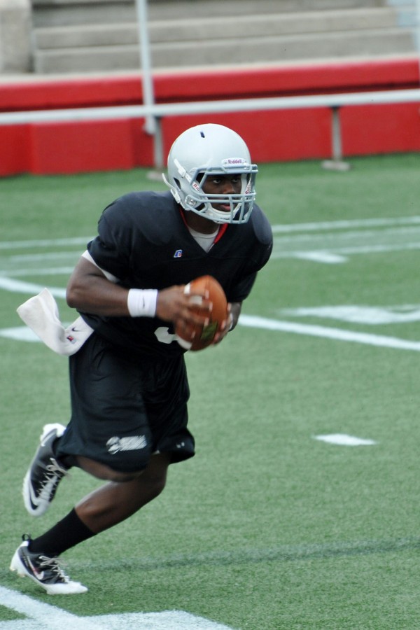 Quarterback Laquintin Caston runs plays with the offense at practice on Saturday.