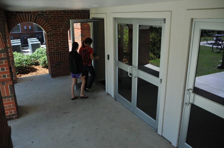 Students enter Scholars Hall on Wednesday morning under the watchful eye of one of the many security cameras across campus. Although it is not an actual surveillance capture, this photo was taken from the same vantage point as one of them.