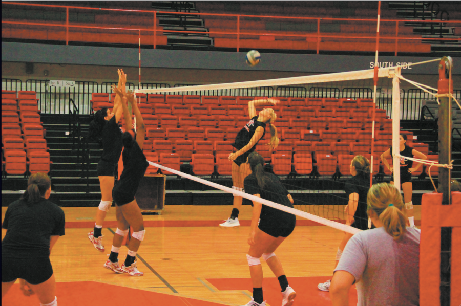 Outside hitter Jennifer Brandt from Wallis and middle blocker Jasmine Harris from Placentia put up a firm block against right side hitter Rachel Yezak from Houston at practice on Aug. 12 in Stopher Gym.