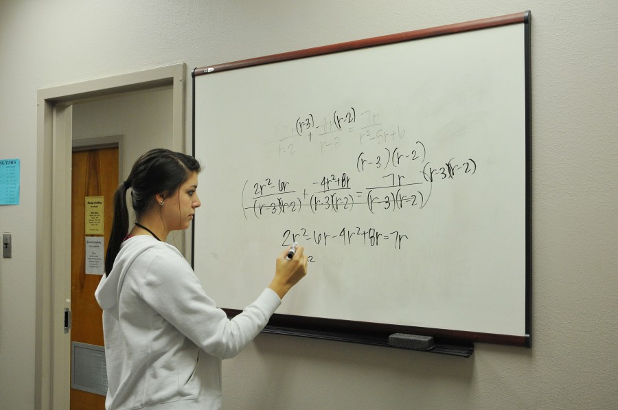 Brittney Cortez, accounting sophomore from Thibodaux, solves a math problem while tutoring MATH 003 students Khristian Prestenbach, sociology sophomore from Houma, and Bryce Dufrene, finance freshman from Lockport, in the Tutoring Center on Tuesday.