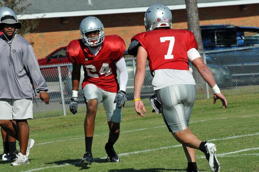 Dalton Hillard Jr., #24, from New Orleans practices with Siegan Vergenal, #7, from New Iberia at football practice on Tuesday.