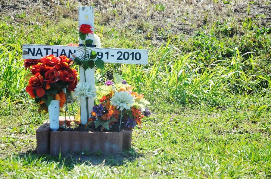 In remembrance of Nathan Trepagnier a cross decorated with flowers stands on Bowie Road.