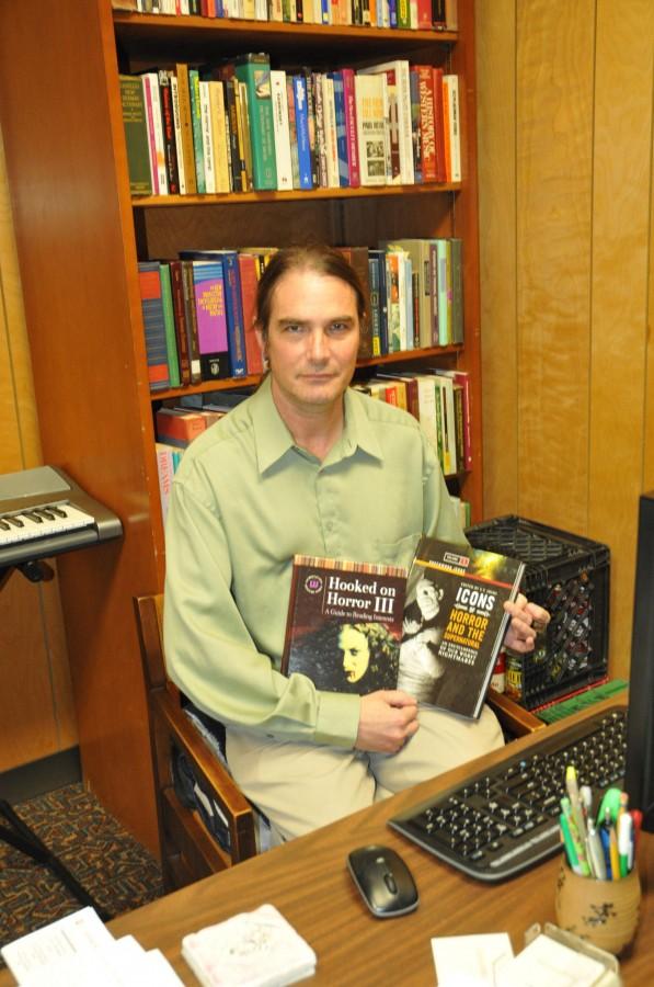 Tony Fonseca, assistant librarian at Ellender Memorial Library, shows off some of the books that he has co-edited and co-authored on Tuesday in his office located in the reference section of Ellender Memorial Library.