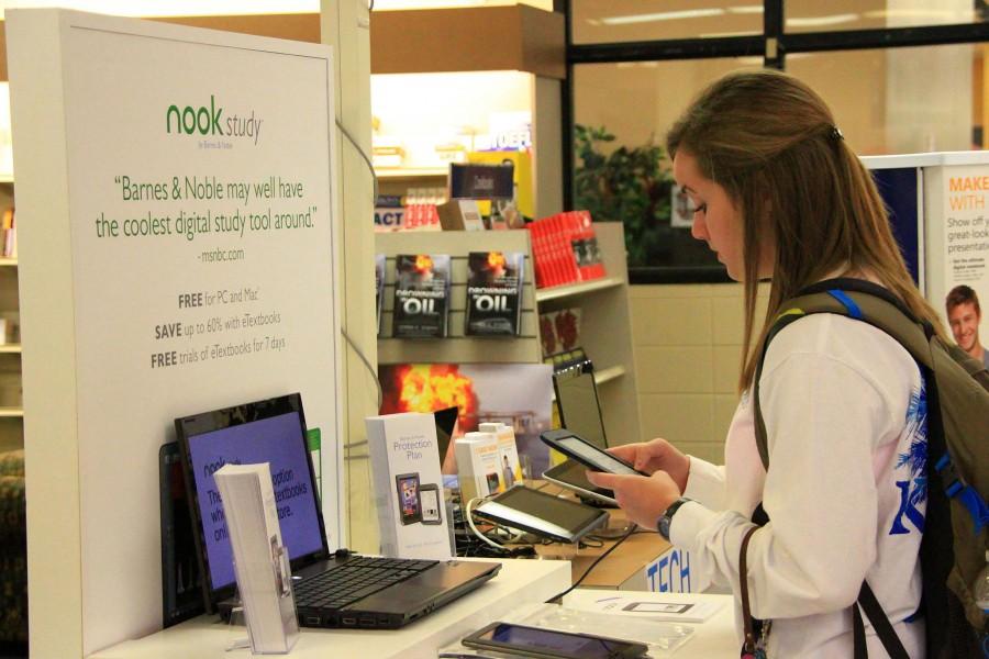 Interested in the technology available for purchase in the Bookstore, Anna Catherine Lee, freshman from Baton Rouge, browses the smart pads and Nooks on Friday.