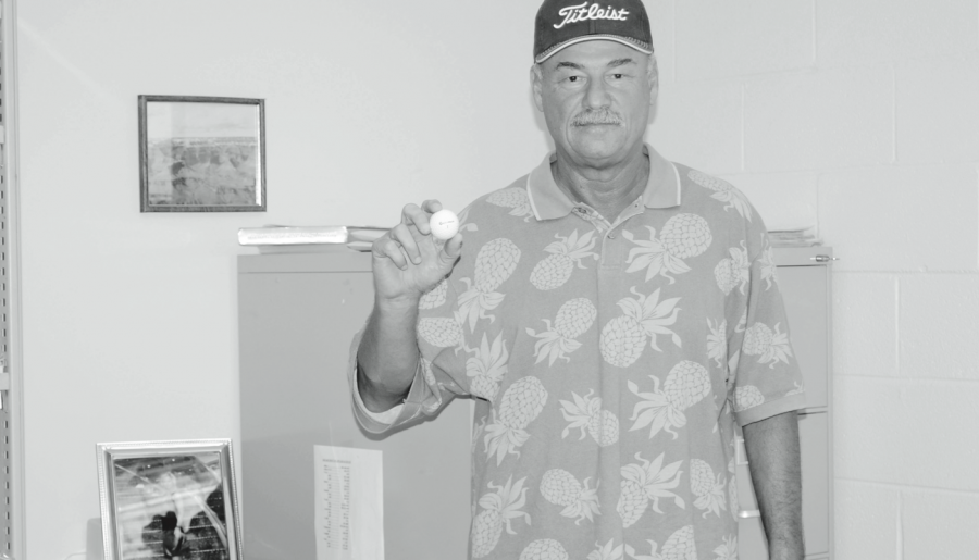  Michael Pemberton, assistant proffesor of petroleum services, holds up his hole-in-one golf ball.