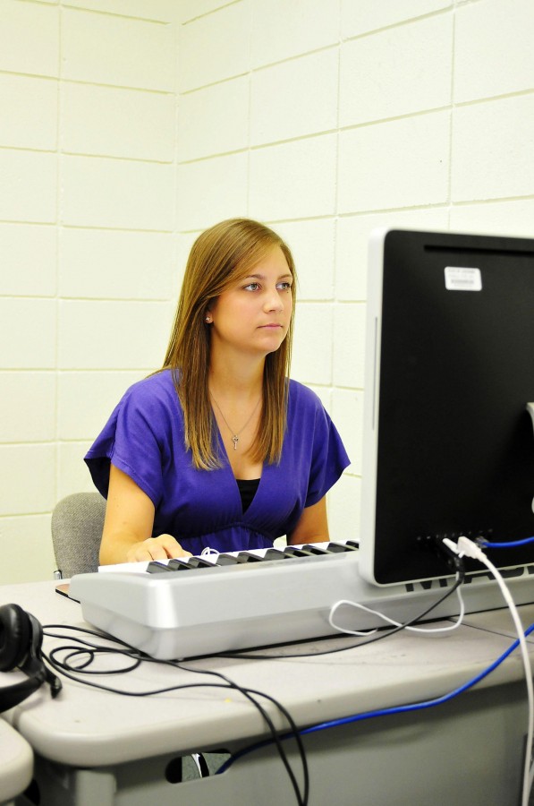During a break in the Talbot Music Lab, Maegan Besson, nursing senior from Houma, logs in to Moodle to check for updated grades.