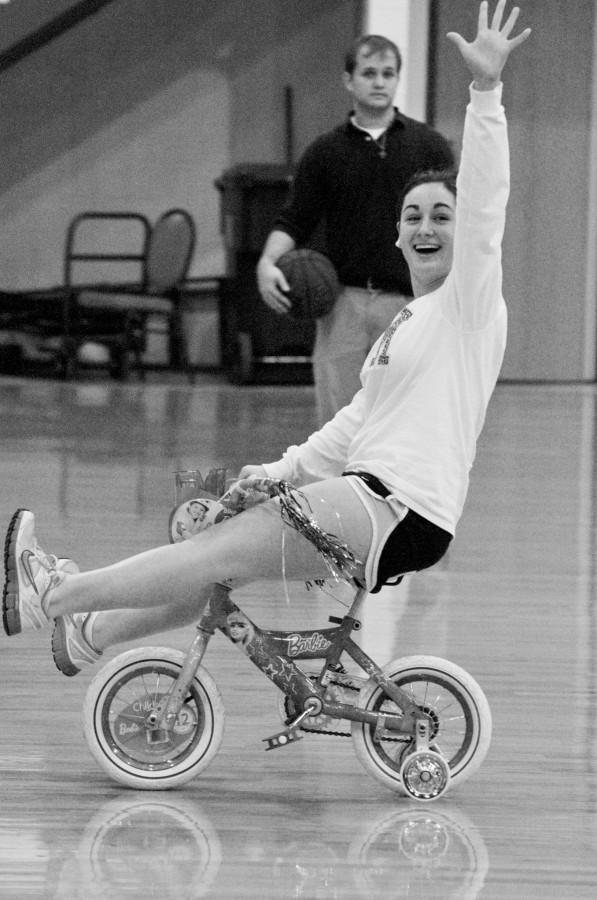 Elise Rau, education sophomore from Houma, celebrates after winning the mini bike race at the men’s basketball game half time show on Jan. 25.