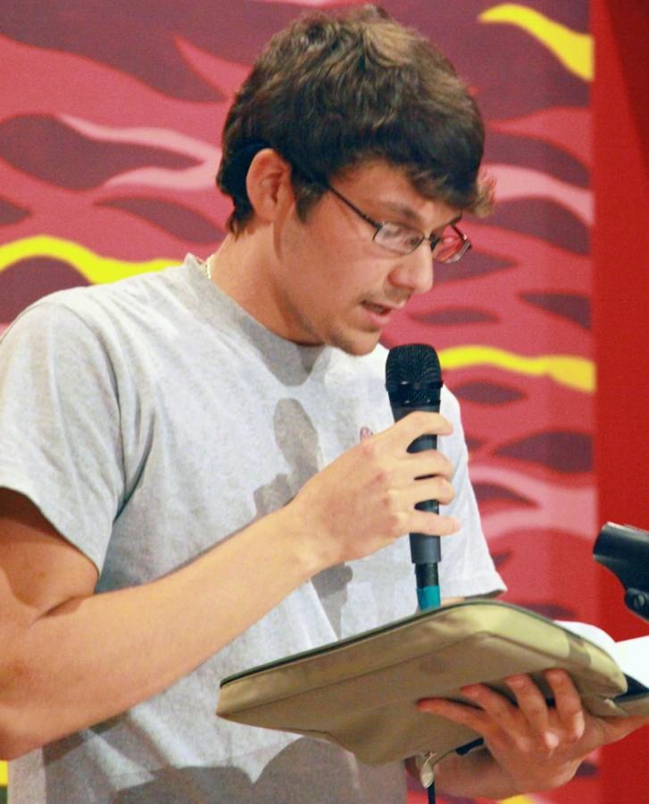 Benjamin Chouest, business administration sophomore from Galliano, reads from the Bible at the Baptist Collegiate Ministry’s Coffee House.