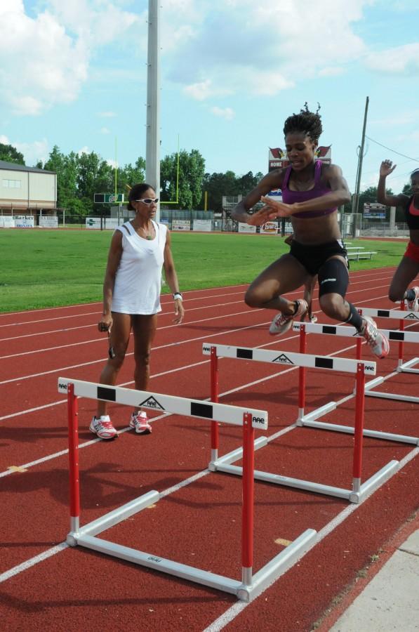 Victoria Williams does quick hurdles as part of the women’s track team drills at their practice on March 29.