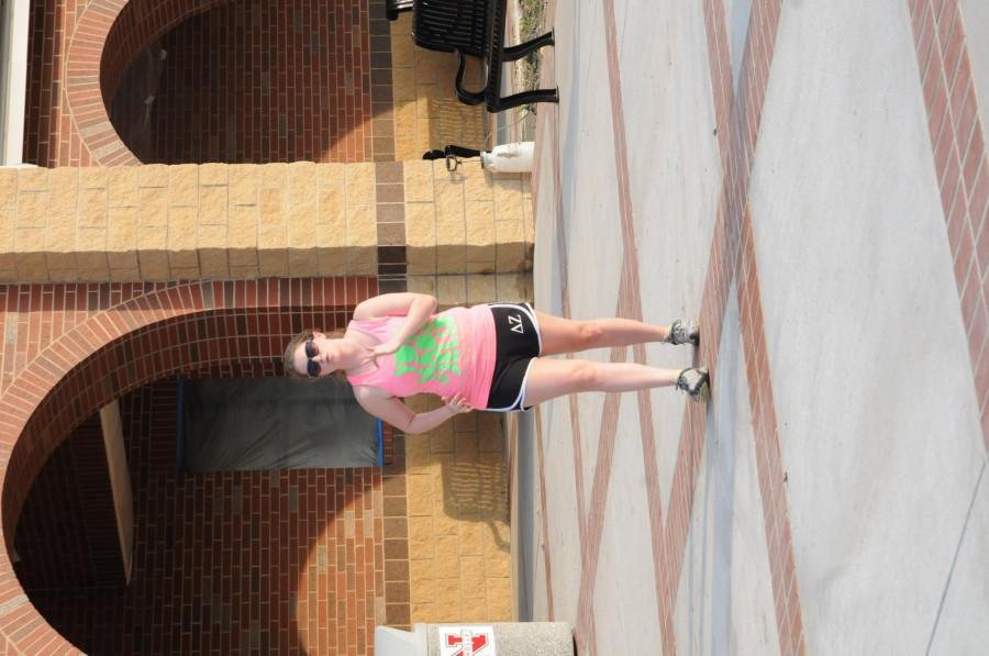 Alicia Kozak, graduate student, warms up Tuesday for the womens walk for National Womens Health and Fitness Week.