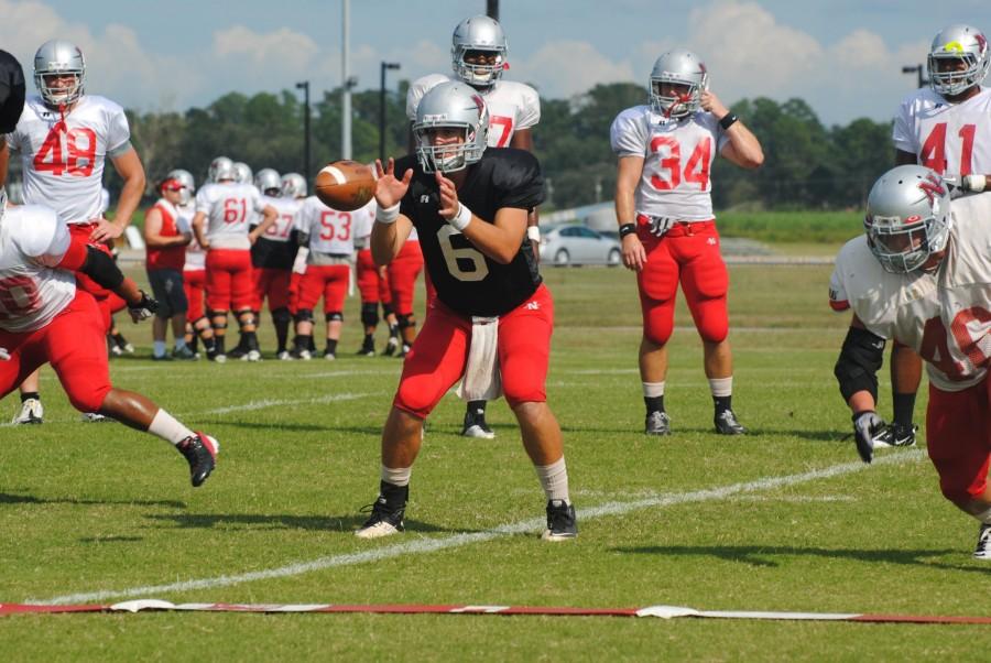 Nicholls quarterback Landry Klann takes a snap during football practice on Wednesday afternoon on the practice field.