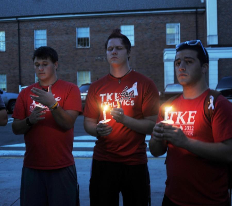 TKA members Justin Meaux, Rynn Porche and Zach Begoun take part in the Take Back The Night candlelight vigil on Oct. 23 to end domestic violence.