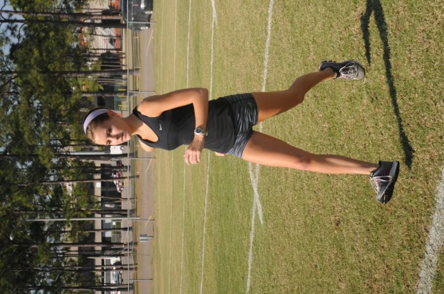 Sarah Pressley, junior cross country runner from Baton Rouge, runs her daily laps on the practice football field on Nov. 1.
