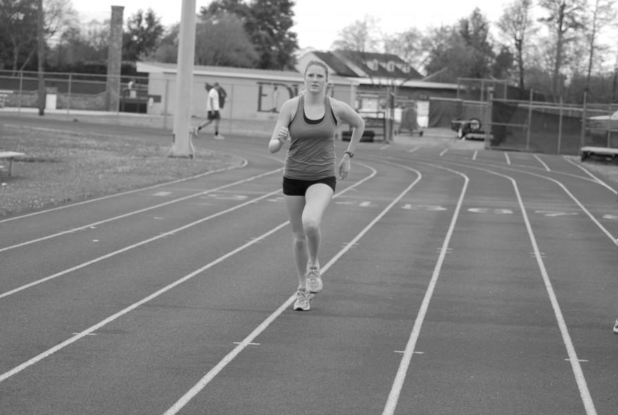 Tessini Carrutherns, communication disorders freshman from Vernon, B.C., Canada, runs during track and field practice Thursday, March 22 at the EDW track. Carrutherns is a 1500 meter and 800 meter runner.