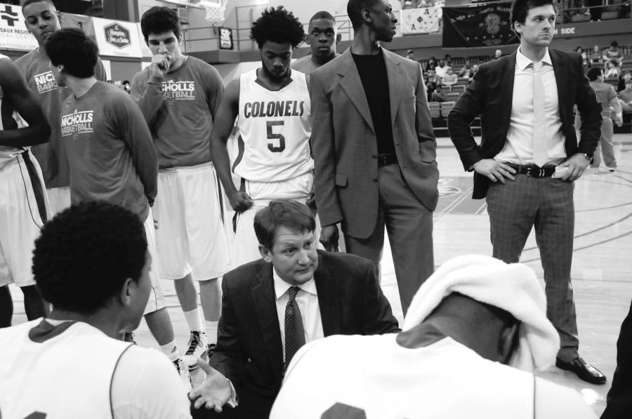 Head Coach J.P. Piper gives a pep talk to the men’s basketball team during a timeout at the basketball game on Feb. 24.