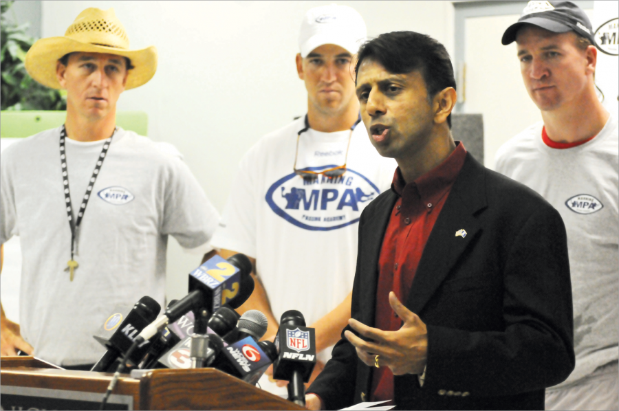 Governor Bobby Jindal talking about funding that will go towards the renovation of Nicholls’ fields for the future Manning Passing Academies, while Cooper, Eli and Peyton Manning listen during the Manning Passing Academy Press Conference.