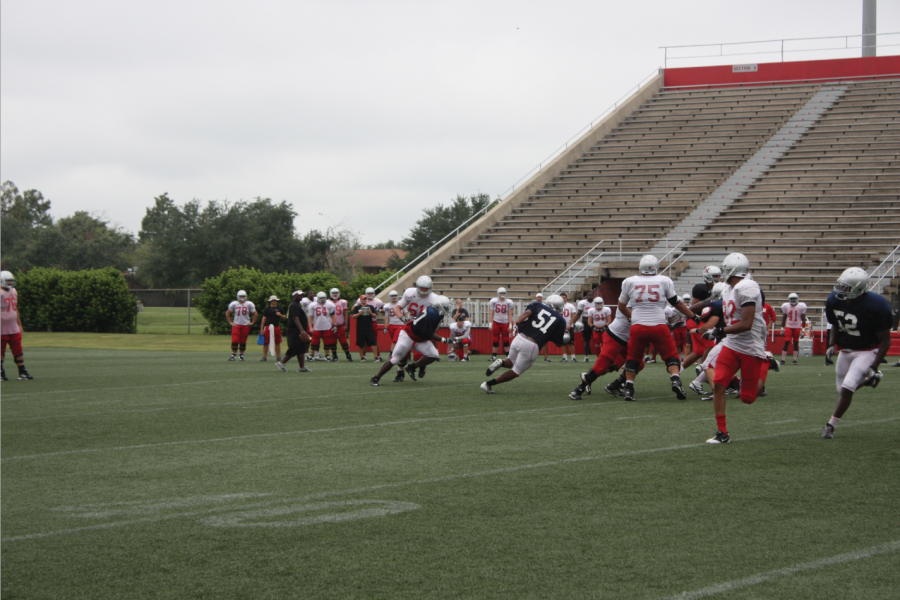 Chris Lorden, 51, a freshman studying general studies from New Orleans runs past his teammates during a practice drill. 