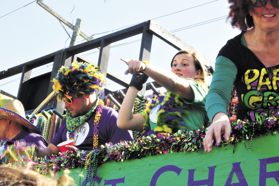 Sammi Jo Acosta, accounting sophomore from Thibodaux, throws toys from the Krewe of St. Charles float in the Cleophas parade last year.