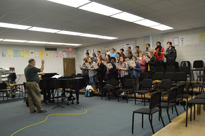 Dr. Kenneth Klaus directs the Nicholls concert choir during rehearsal yesterday.