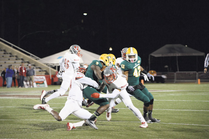 Two Nicholls State University football players tackle a Southeastern Louisiana University player during the Colonels’ meeting with the Lions last November. Football players are highly susceptible to head injuries during games.
