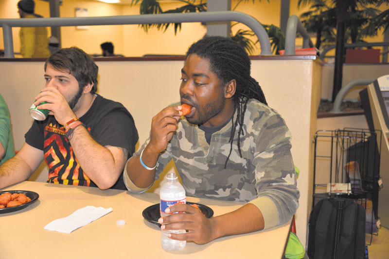 Danzel Major, a Psychology Senior from New Orleans, participating in the Student Programming Association’s Spicy Chicken Eating Contest on Wednesday afternoon.