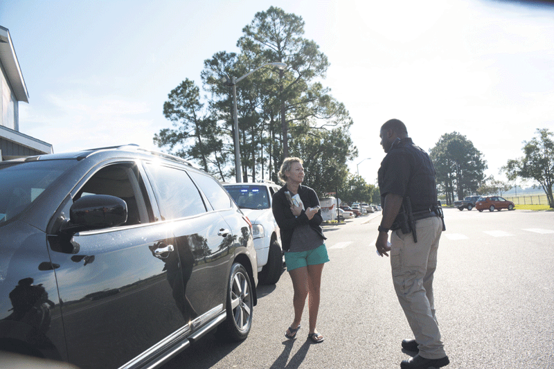 Nicholls Police Officer White assists a student after an automobile accident.                  