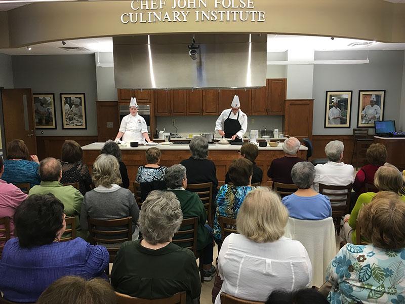 Mallory Miller, culinary sophomore from Sulphur, and Chef John Kozar demonstrate a crepe recipe at the John Folse Culinary Institute on March 4.