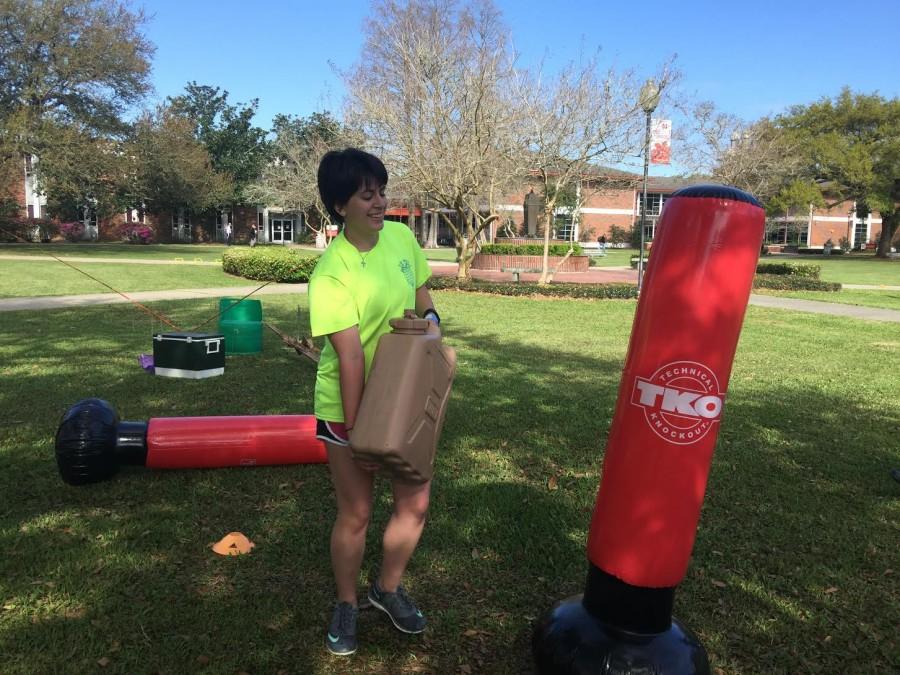  Ashleigh Aubin, a Biology pre-med major from Thibodaux, completes the World Water Day obstacle course in the quad.