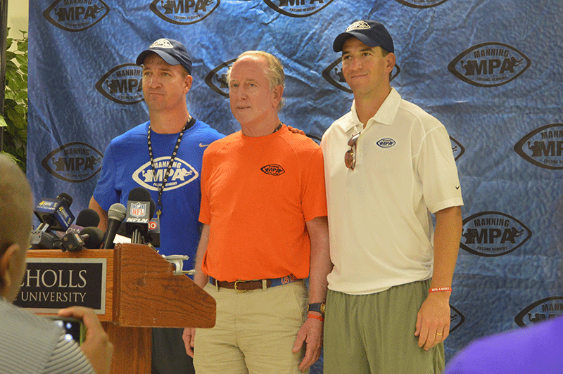 From left to right: Peyton, Archie and Eli Manning stand for a group photo before the Manning Passing Academy press conference at Nicholls State University this morning.