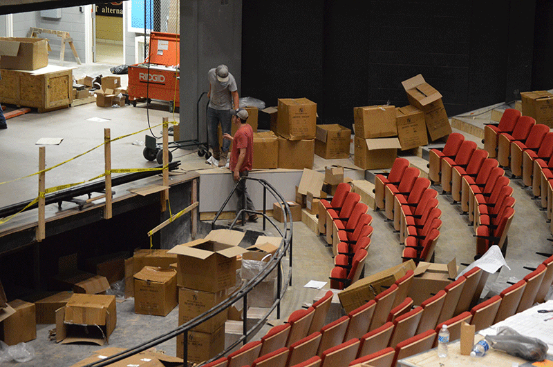 Construction workers working on renovations in the Mary M. Danos theater yesterday morning. 