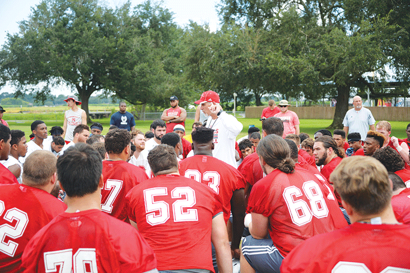 Head coach Tim Rebowe meets with all football players post practice on August 22.