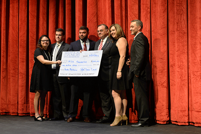 President Murphy accepts a $1 million check on behalf of Nicholls from the Mary and Al Danos Family Foundation.